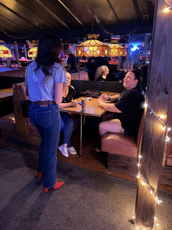 Caitlin talking with neighbors at a local restaurant