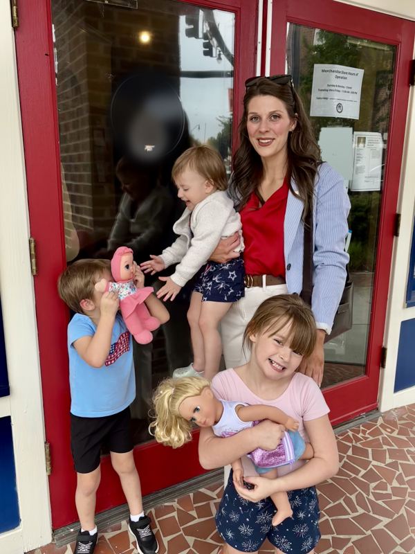 Caitlin with her three children outside a local storefront